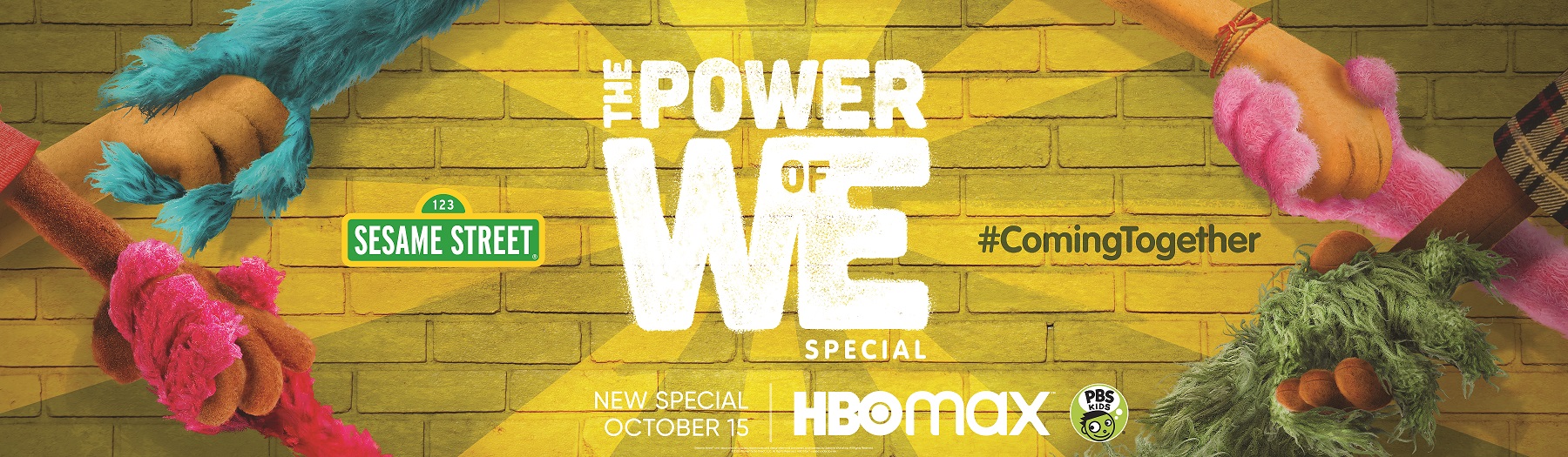Furry muppet hands clasp one another against a yellow brick background. In the center of the image, it says "The Power of We Special". The Sesame Street logo appears to the left, #ComingTogether appears to the right, and at the bottom it says "New Special October 15" beside the HBO Max logo and PBS KIDS logo.
