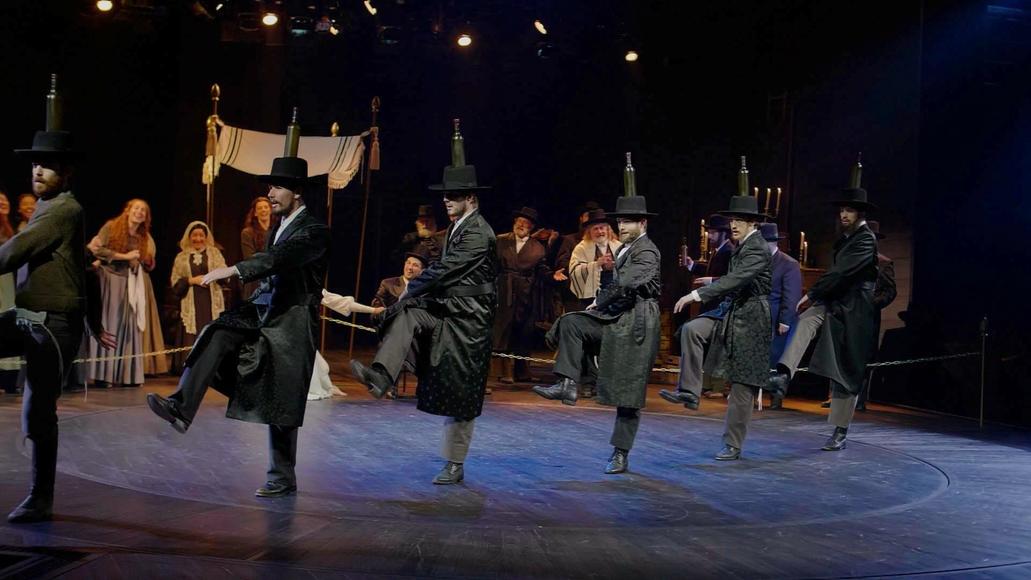 Still of people dancing in a performance of Fiddler the musical.