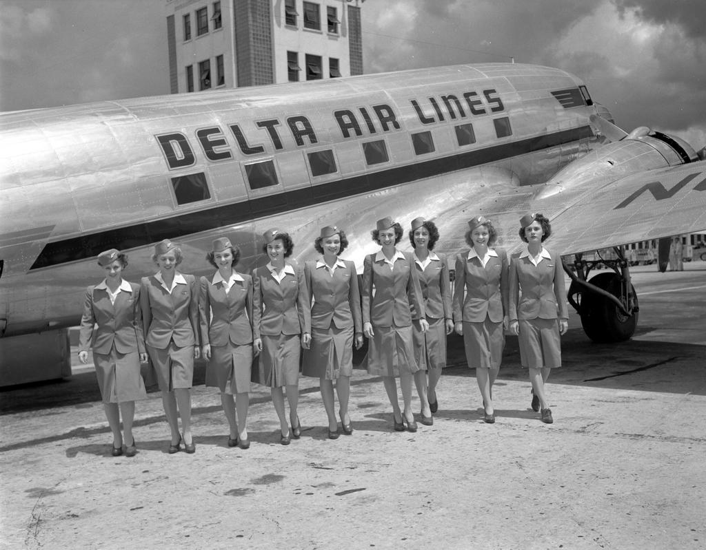 stewardesses in front of plane